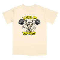 A cream-colored short-sleeve t-shirt with a graphic print of a muscular man lifting a barbell, surrounded by the text 'LOADED ON PEPTIDES' in yellow and black.